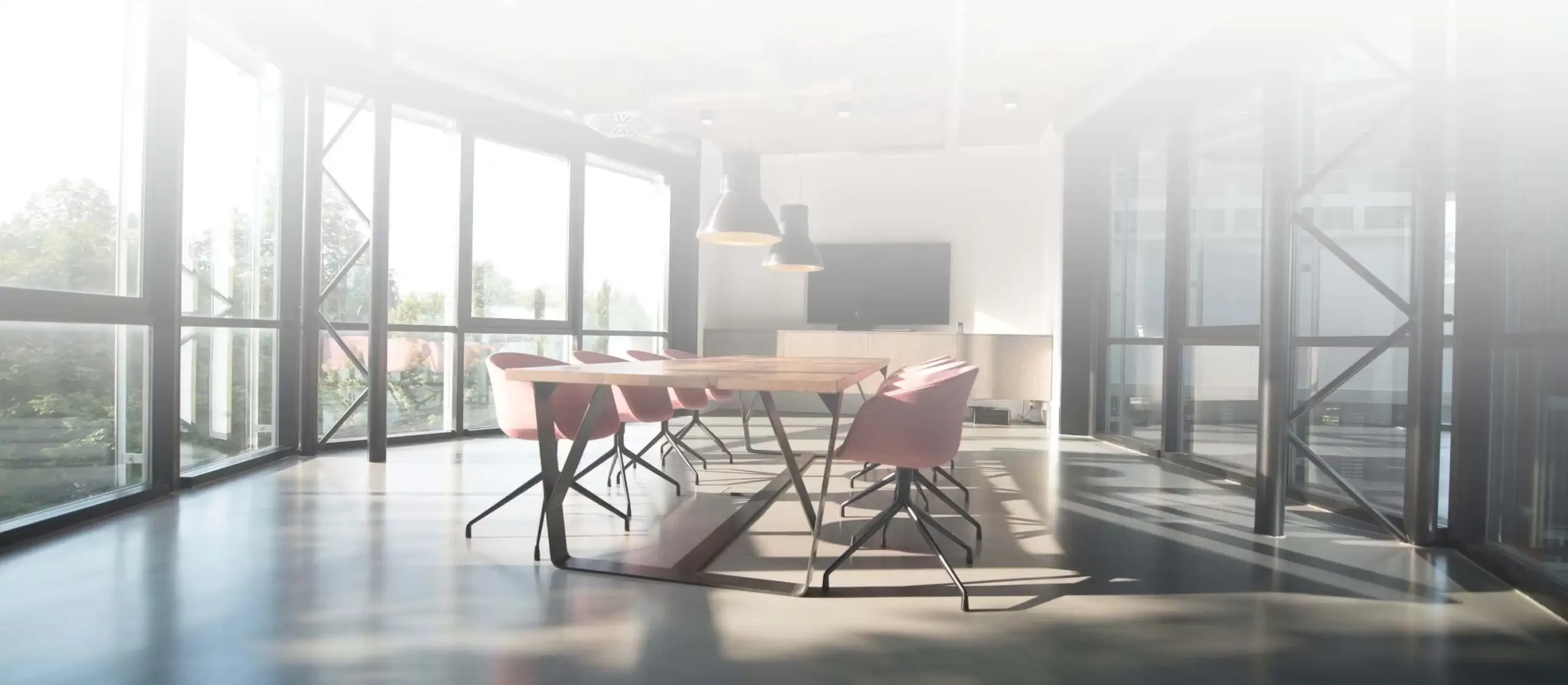 Clean office room with desk and chairs.